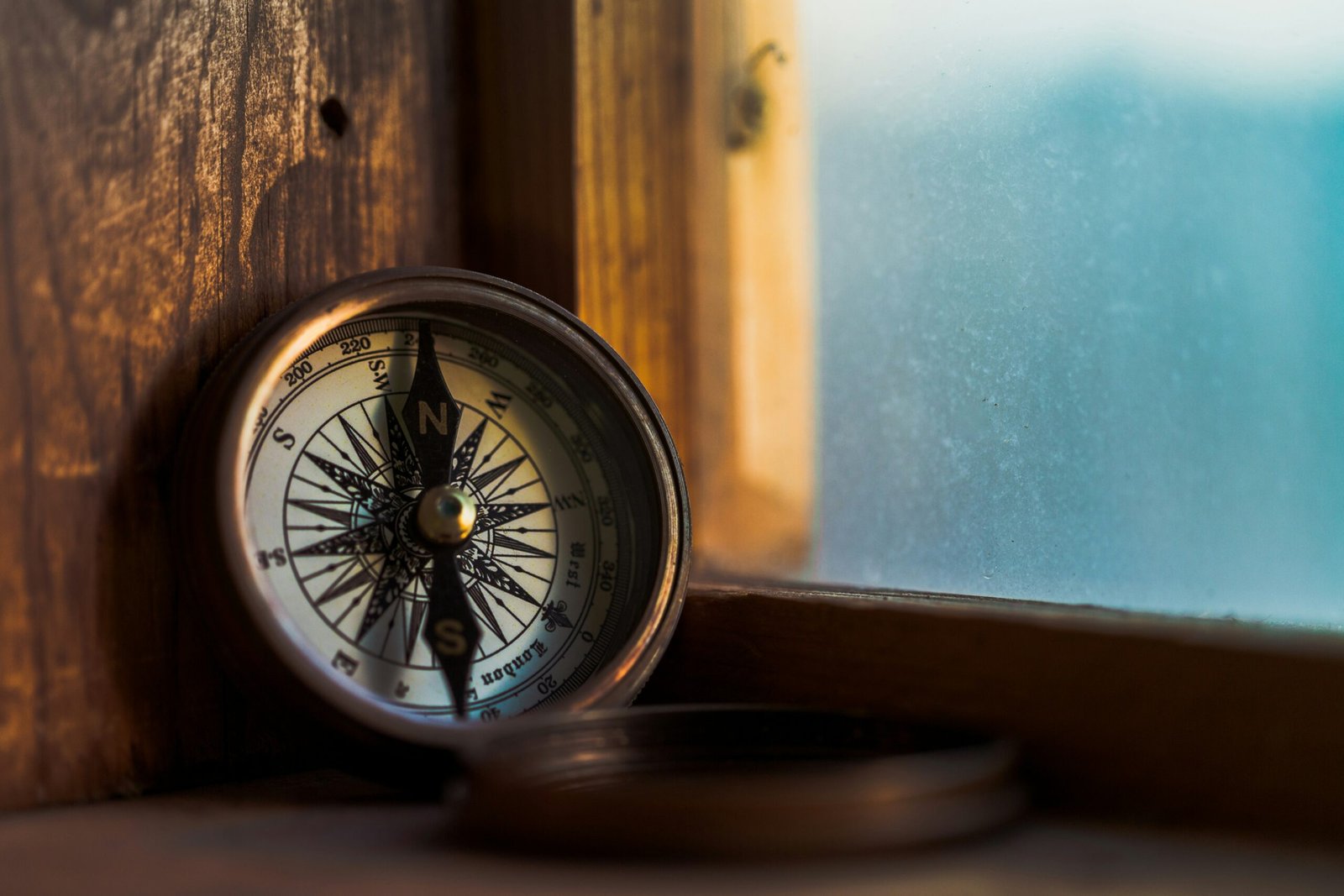 Photo of a compass propped in window