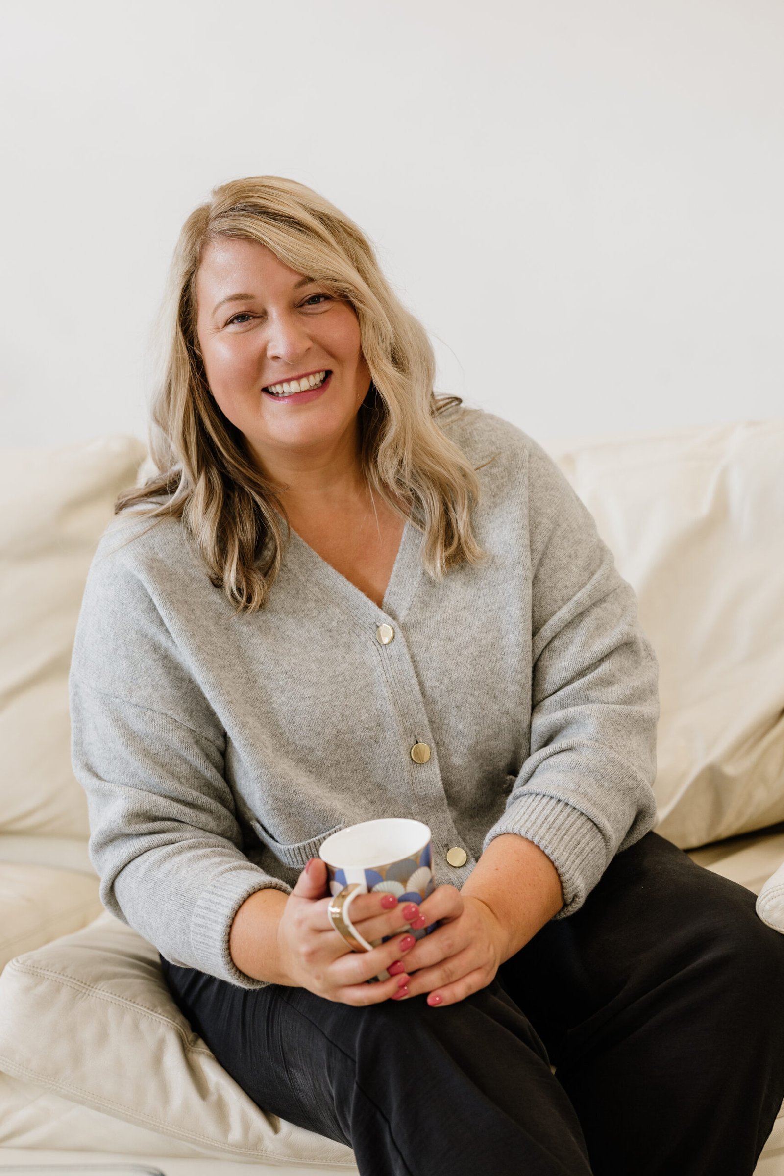 Georgina Hall Georgina Hall, burnout specialist looks at camera holding a coffee cup
