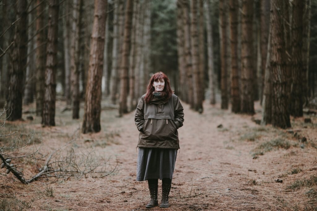 Woman walks in woods to manage perimenopause anxiety symptoms