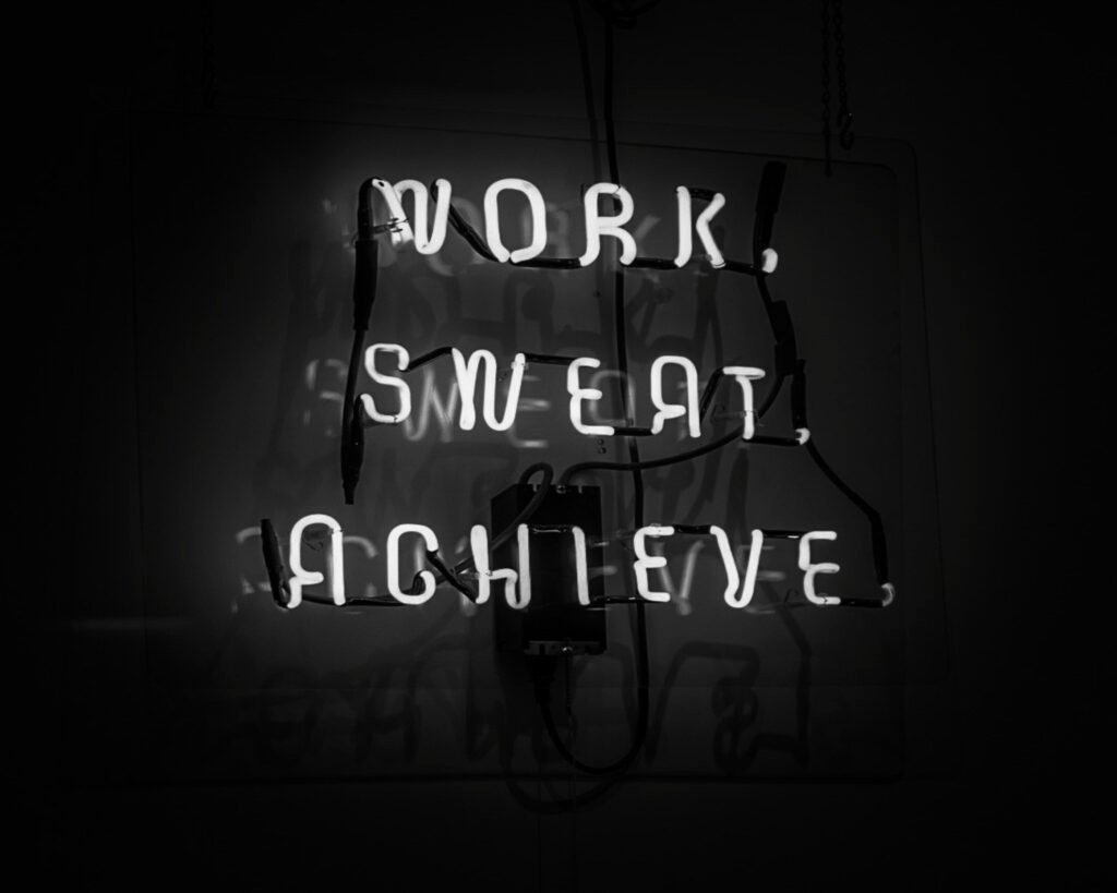 Neon sign reads work, sweat, achieve. How to stop hot flushes without HRT.